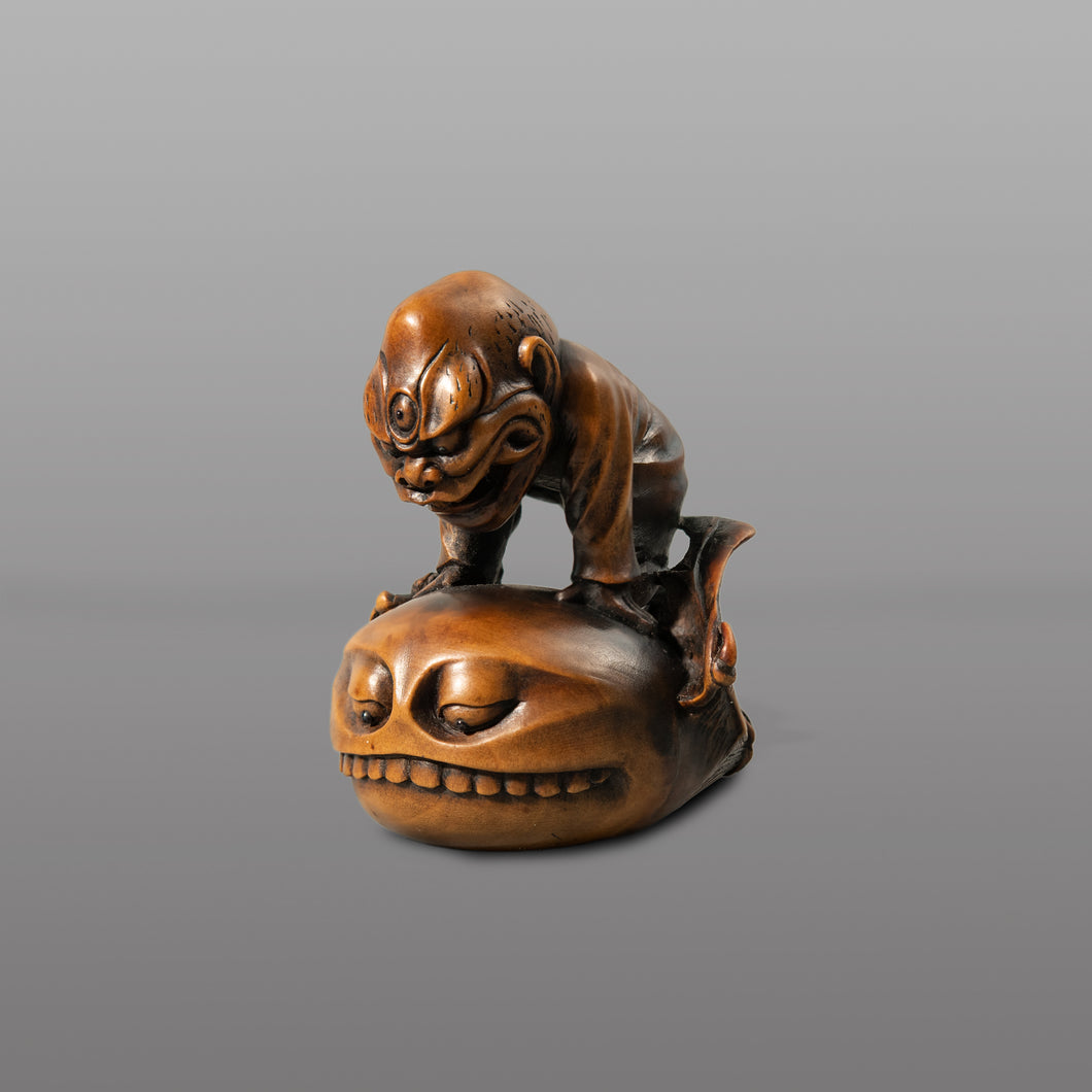 Netsuke - Demon on winged mokugyo drum