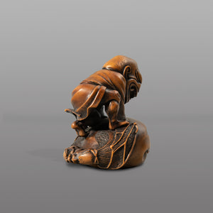 Netsuke - Demon on winged mokugyo drum